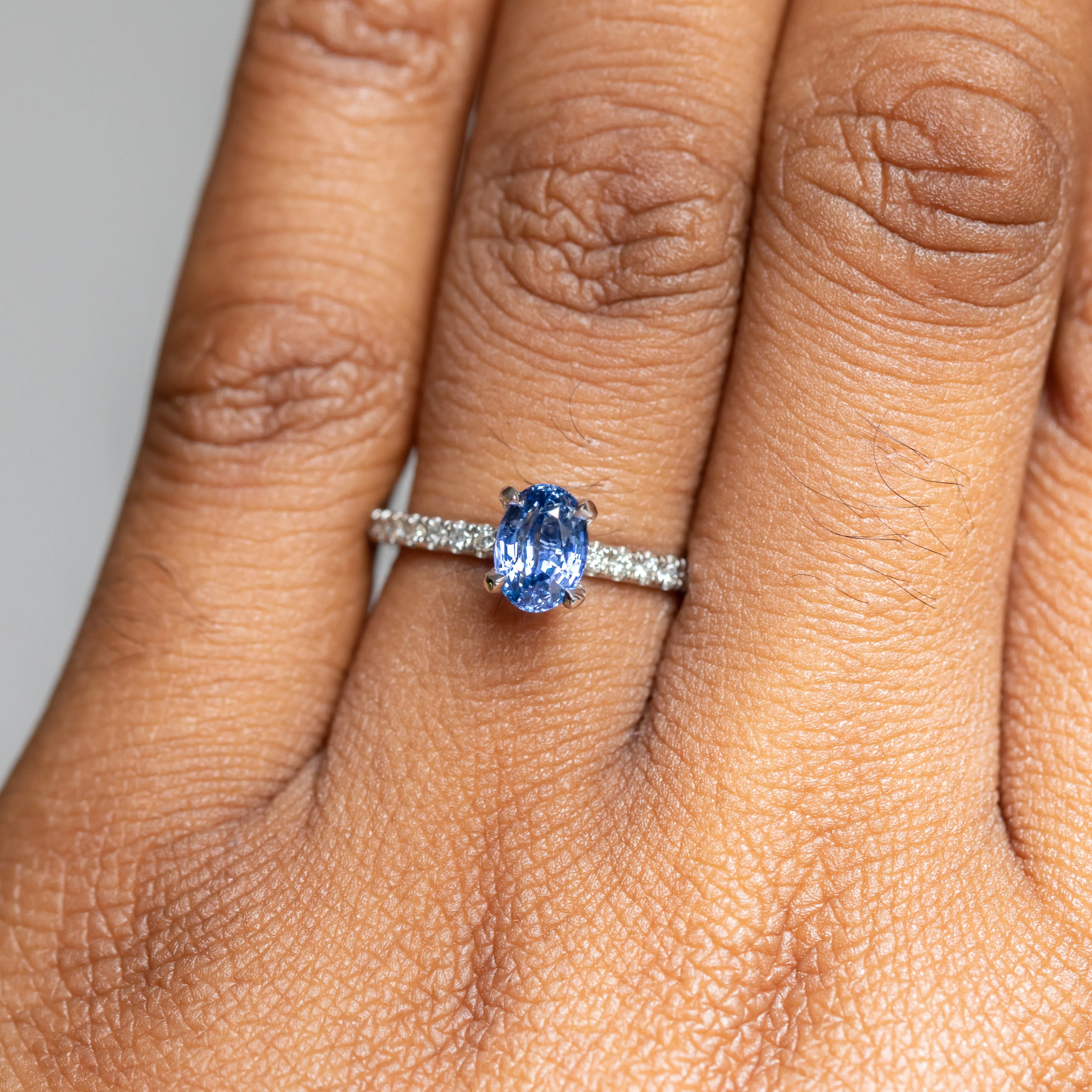 1.12ct Oval Periwinkle Blue Sapphire Solitaire with French Set Diamonds In 14K White Gold