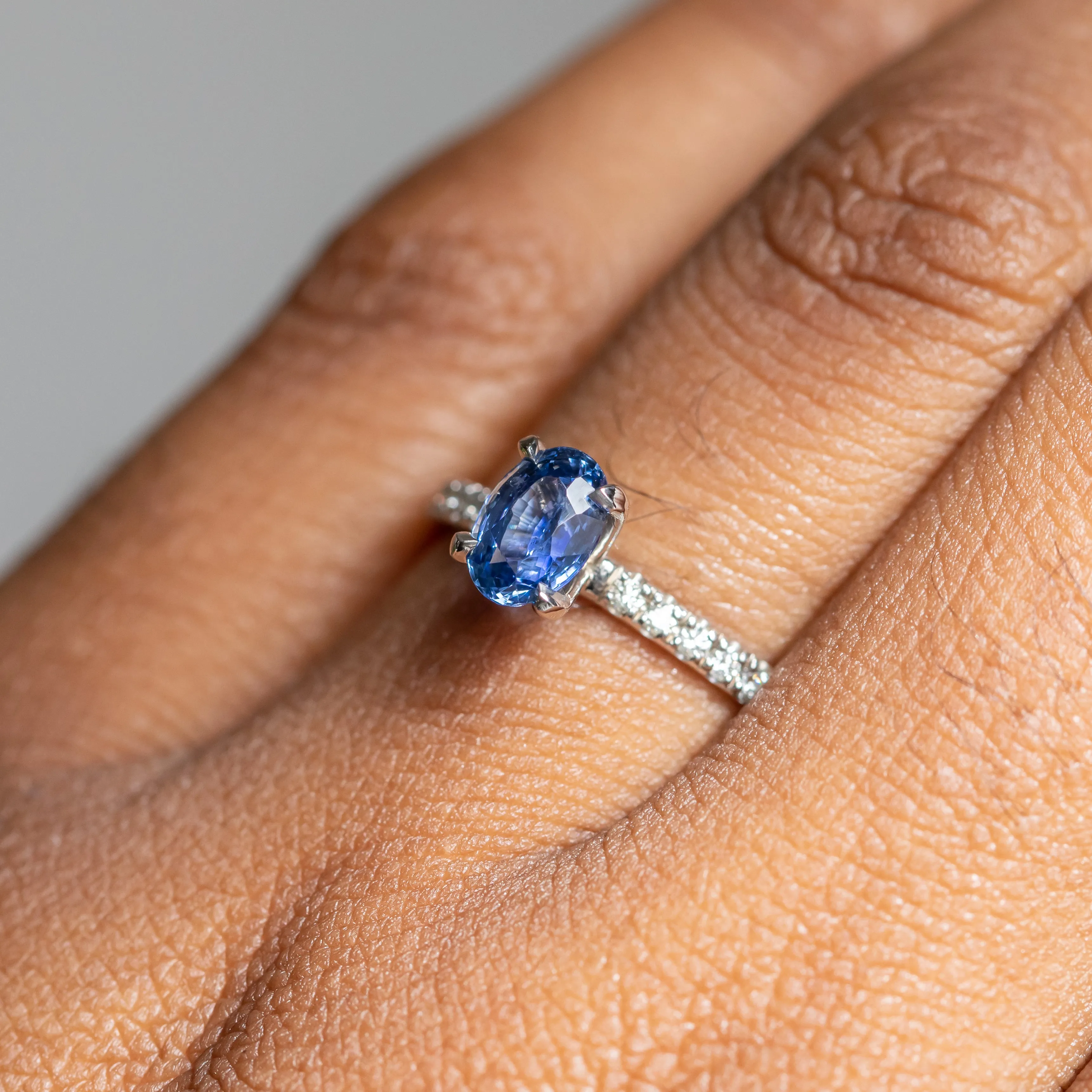 1.12ct Oval Periwinkle Blue Sapphire Solitaire with French Set Diamonds In 14K White Gold